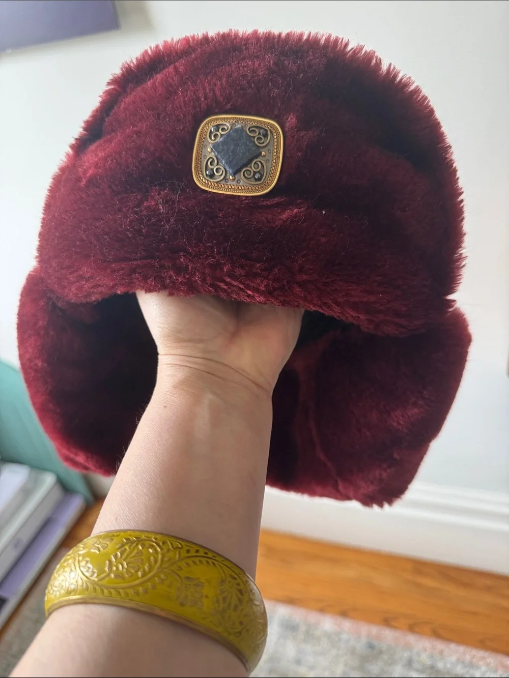 Plush Faux Fur Hat in Deep Burgundy with Decorative Medallion